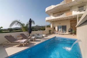 a villa with a swimming pool and a patio at Nerida Luxury Villas in Kastéllion