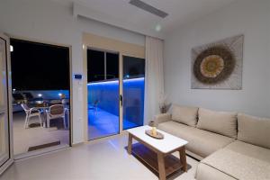 a living room with a couch and a table at Nerida Luxury Villas in Kastéllion