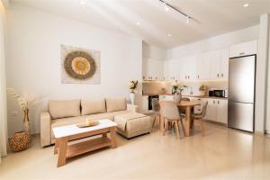 a living room and kitchen with a couch and a table at Nerida Luxury Villas in Kastéllion