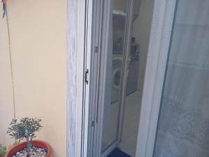 a shower with a glass door in a bathroom at Studio Kastra in Thessaloniki +10 photos