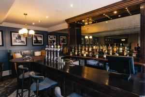 a bar with a lot of bottles of alcohol at The Seafield Arms Hotel Cullen - Self Catering in Cullen