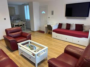 a living room with two couches and a flat screen tv at gîte des gorges de Daluis appartement 2 pieces in Daluis