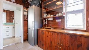 a kitchen with a refrigerator and a window at Traka Cottages in Sedgefield