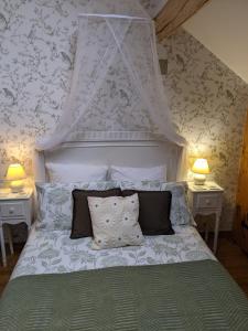 a bedroom with a white bed with a canopy at L'Amelia Les Trois Petites Maisons in Cromac +24 photos