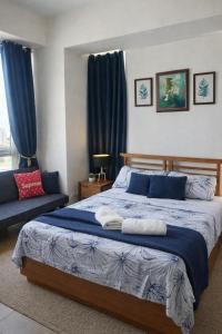 a bedroom with a large bed with blue curtains at Mactan Newtown Deluxe 8 Boulevard in Punta Engaño +38 photos