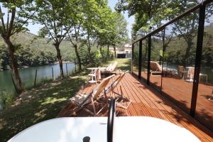 a wooden deck with a table and chairs on it at VILLA La Finca - Privada in Vieira do Minho