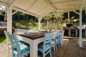 a wooden table and chairs under a pavilion at Casa Athena - Goelba in Portoferraio