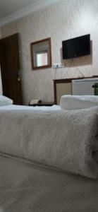 a hotel room with two beds and a flat screen tv at HOTEL Kenan in Doğubayazıt +15 photos