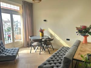 a living room with a table and a couch at Lovely Spacious Apartment in Zandvoort