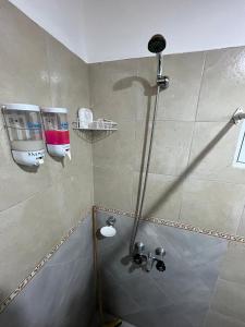 a shower with a glass door in a bathroom at El Cardiel in Gobernador Gregores +17 photos