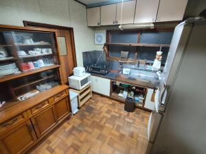 a kitchen with a sink and a refrigerator at オホーツクハウスえんがる in Engaru