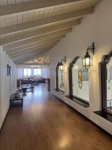 a large room with a wooden floor and white walls at Hotel Santa Catalina in Río Cuarto