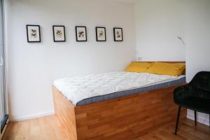 a bed in a room with photos on the wall at Ferienhaus Sjö Hus Pülsen - Köhn in KÃ¶hn