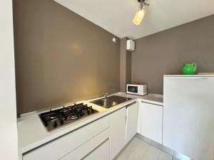 a kitchen with a stove and a sink in it at Appartamento Tilatti in Grado +5 photos