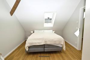 a bedroom with a bed in a attic at Residenz R1 App 1 in Behrensdorf
