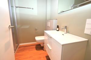 a bathroom with a white sink and a toilet at Residenz R1 App 2 in Behrensdorf +25 photos