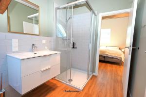 a bathroom with a glass shower and a sink at Residenz R1 App 3 in Behrensdorf +31 photos