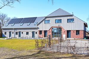 a house with solar panels on the side of it at Residenz R1 App 3 in Behrensdorf