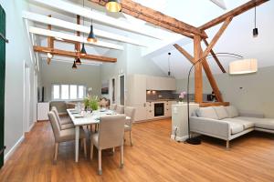a living room and dining room with a table and chairs at Residenz R1 App 4 in Behrensdorf