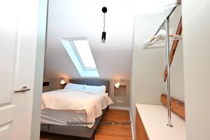 a bedroom with a bed and a skylight at Residenz R1 App 4 in Behrensdorf