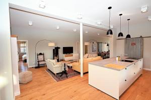 a kitchen and living room with a couch and a table at Residenz R1 App 5 in Behrensdorf