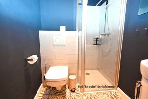 a bathroom with a toilet and a shower at Residenz R1 App 5 in Behrensdorf +53 photos