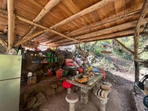a kitchen with a refrigerator and a table with food at Patziapa in Santiago Atitlán