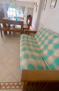 a couch sitting in a living room next to a table at Casa Colibrí zona Parque Saavedra de La Plata in La Plata