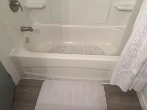 a white bath tub sitting in a bathroom at Gull lake in Winnipeg +15 photos