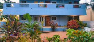 a blue house with plants in front of it at Aadhya guest house in Tiruvannāmalai