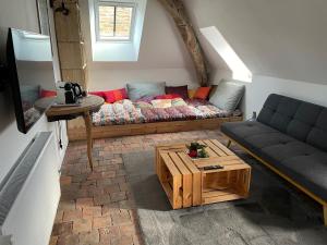 a living room with a couch and a coffee table at Le Petit Monde de Molly in Toucy