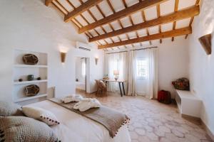 a bedroom with a large white bed in a room at Agroturismo Rafal Rubí in Alaior