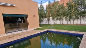 a house with a swimming pool in a yard at Prestige Villa in Marrakesh