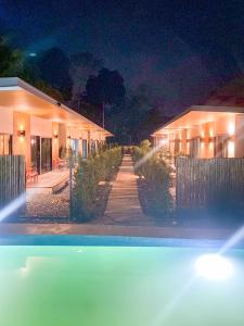 a row of houses at night with a pool at Aonang Green Tree in Ao Nang 