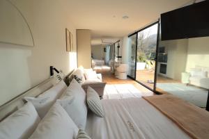 a bedroom with a white bed with white pillows at VILLA La Finca in Vieira do Minho