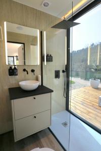 a bathroom with a sink and a mirror at VILLA La Finca in Vieira do Minho