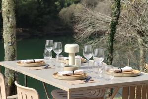 a white table with wine glasses and plates on it at VILLA La Finca in Vieira do Minho