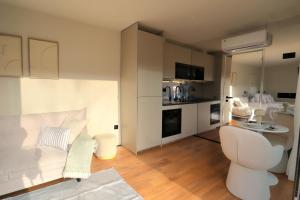 a living room with a white couch and a kitchen at VILLA La Finca in Vieira do Minho +80 photos