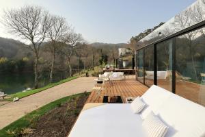a house with a deck with a view of a lake at VILLA La Finca in Vieira do Minho