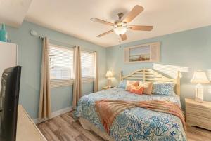 a bedroom with a bed and a ceiling fan at Goin Coastal Emerald Beach Unit 729 in Panama City Beach +58 photos
