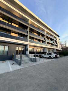 a building with a car parked in a parking lot at LVO Studio in Bîrlad