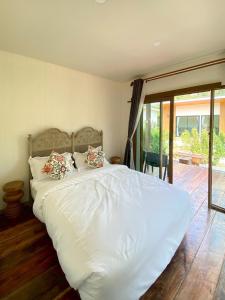 a large white bed with pillows in a bedroom at Aonang Green Tree in Ao Nang  +87 photos