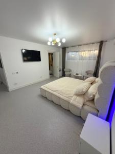 a bedroom with a large bed and a couch at LVO Studio in Bîrlad