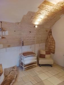 a room with a bunk bed and a chair at Dimora Bianca Ostuni in Ostuni +4 photos