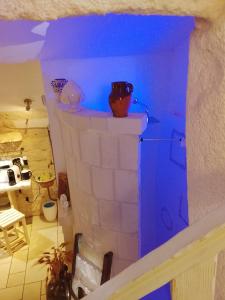 a model of a kitchen with blue lights on a fireplace at Dimora Bianca Ostuni in Ostuni