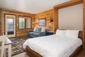 a bedroom with a bed and a couch in it at 564 Silvercreek Inn in Granby +27 photos