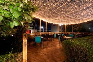 a restaurant with tables and chairs under lights at Sea Vista Hotel in Sveti Vlas +32 photos