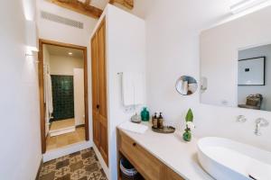 a white bathroom with a sink and a mirror at Agroturismo Rafal Rubí in Alaior +37 photos