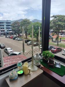 a window with a view of a parking lot at Kluang Countryside Scenery NO LIFT SECOND FLOOR#NETFLIX#RETRO GAME in Kluang