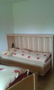 a bedroom with a bed with red flowers on it at Ferienwohnung Wiesengrund in Überlingen